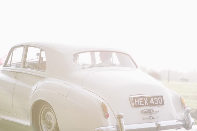 rhinefield house hotel hampshire wedding photographer wedding car driving away into sun