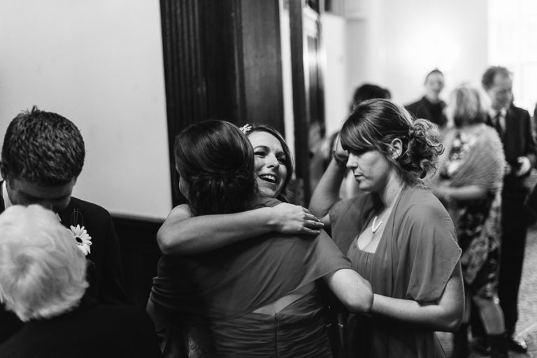 rhinefield house hotel hampshire wedding photographer bride hugging bridesmaid