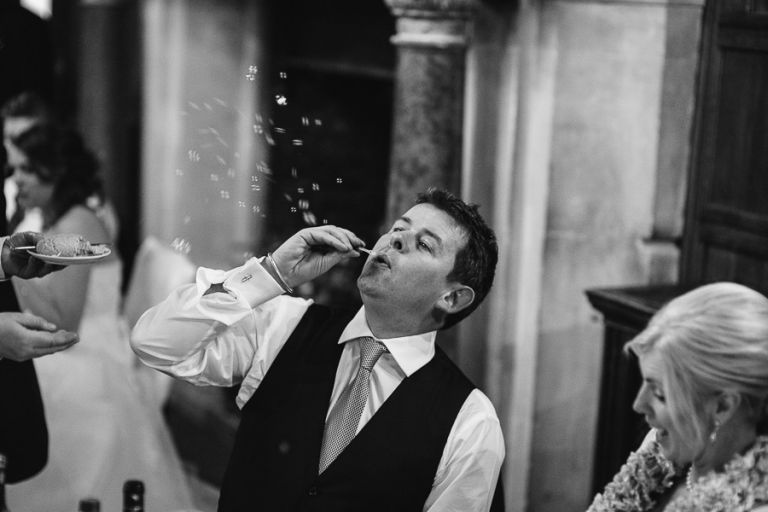 rhinefield house hotel hampshire wedding photographer guest blowing bubbles