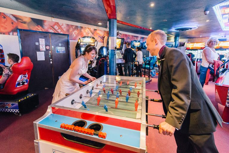 Green House Hotel Bournemouth Wedding Photographer bride and groom playing table football
