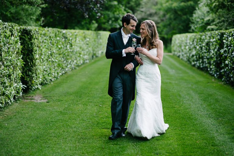 Justin and Carly toasting at a wedding at the Larmer Tree Gardens