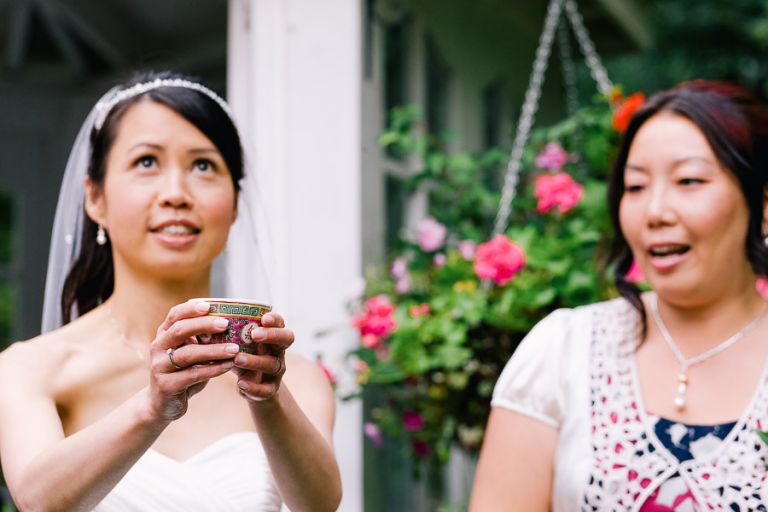 wedding chinese tea ceremony tea being offered outside looking up at sky at Langtry Manor Hotel Bournemouth