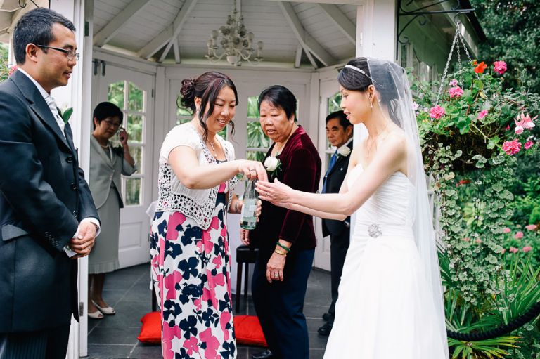 wedding chinese tea ceremony tea being offered by bride at Langtry Manor Hotel Bournemouth