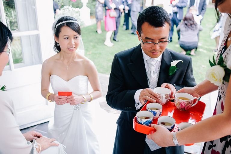 wedding chinese tea ceremony tea being offered by groom at Langtry Manor Hotel Bournemouth