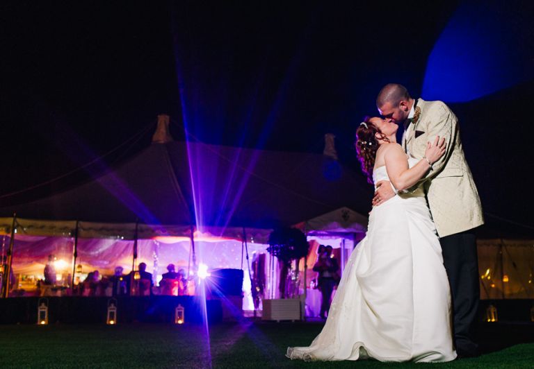 Mike and Allie at Parley manor weddings with guests dancing in the background