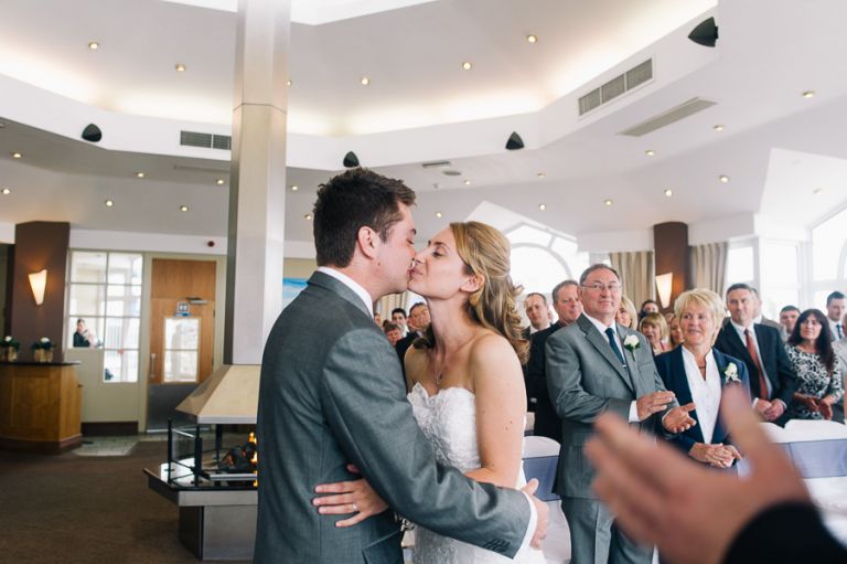 sandbanks bournemouth beach wedding ceremomy bride and groom first kiss
