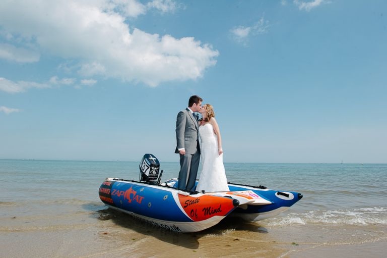 sandbanks bournemouth beach wedding bride and groom kissing on boat