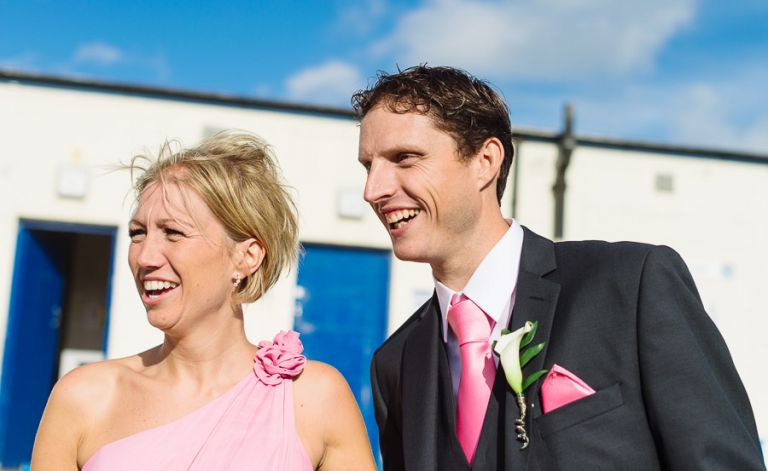 couple smiling at two men having fun at a sandbanks jazz cafe wedding photographer