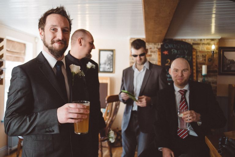 wedding at poole guildhall groom waiting and ready at nearby pub