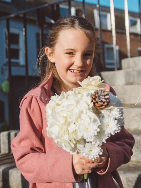 wedding at poole guildhall with young child holding bouquet
