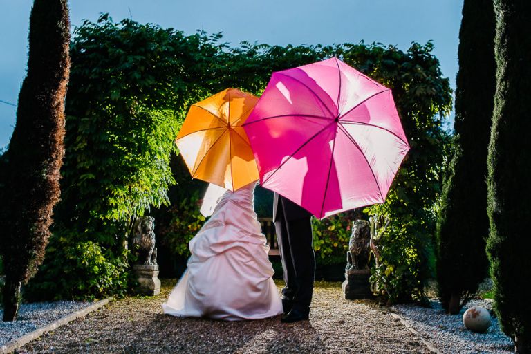 coloured umbrellas at autumnal wedding at orangery wimborne