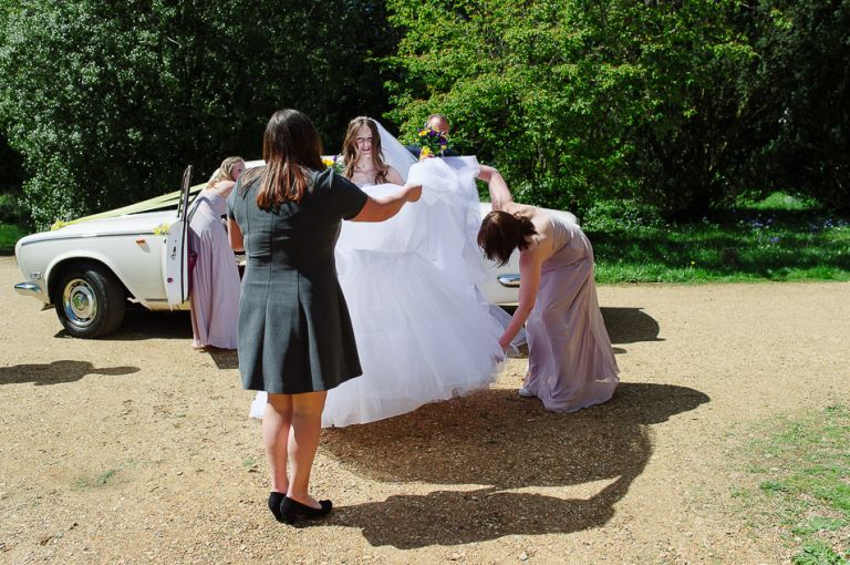 weddings at the Old Vicarage christchurch an new forest - brides dress being straightened
