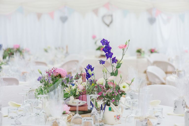 dorset garden marquee wedding details flowers in vintage china teacups
