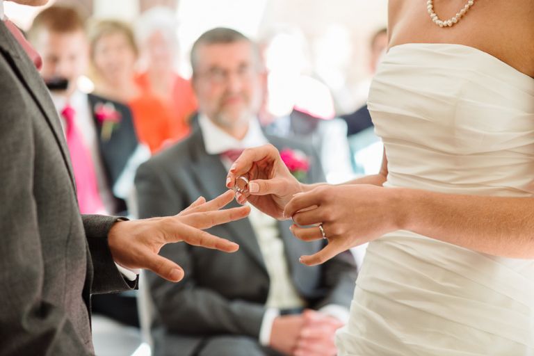 weddings-at-deans-court-wimborne-wedding-photographer-bride putting ring on