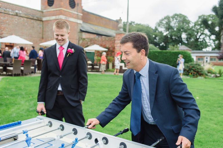 weddings-at-deans-court-wimborne-wedding-photographer-guests playing table football again
