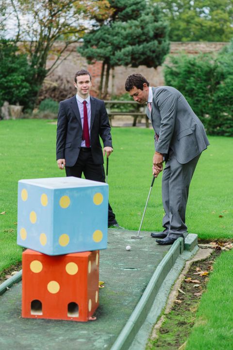 weddings-at-deans-court-wimborne-wedding-photographer-guests playing mini golf