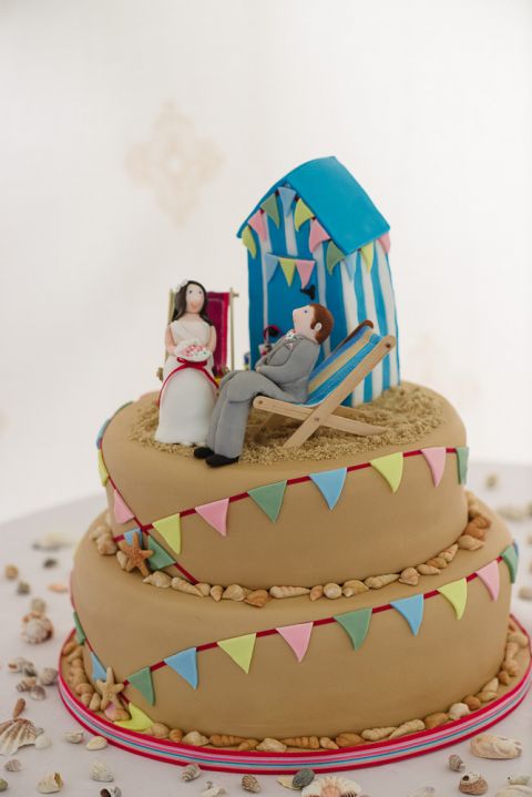 weddings-at-deans-court-wimborne-wedding-photographer-bride and groom wedding cake on beach