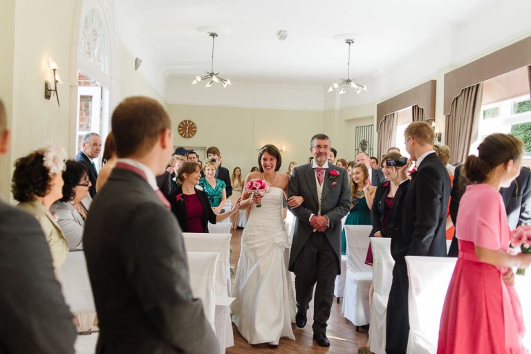 weddings-at-deans-court-wimborne-wedding-photographer-bride come down aisle