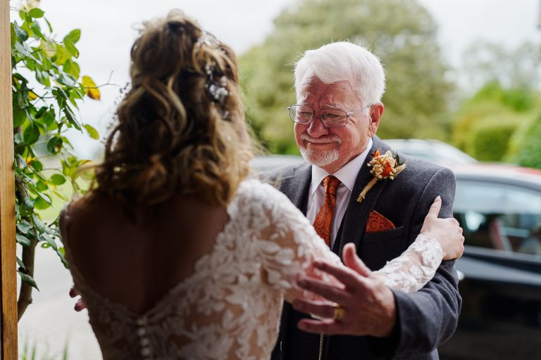 Emotional first look embrace between bride and her father at Pennard Hill Farm Somerset