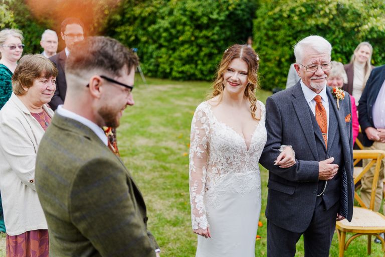 Intimate outdoor micro wedding ceremony under the licensed wooden pagoda at Pennard Hill Farm